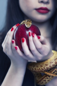 Portrait of a young beautiful woman with a snake.