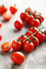 Cherry tomatoes branch on a grey background