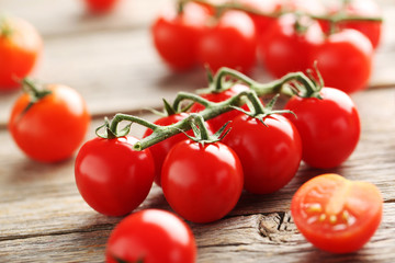 Cherry tomatoes branch on a grey wooden table