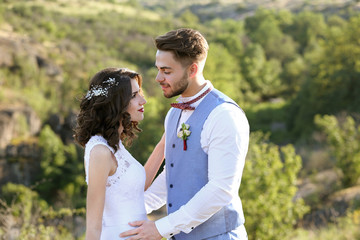 Bride and groom standing over beautiful landscape