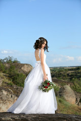 Fototapeta na wymiar Bride standing over beautiful landscape