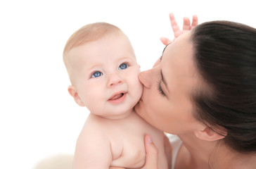 Mother holding little baby indoors