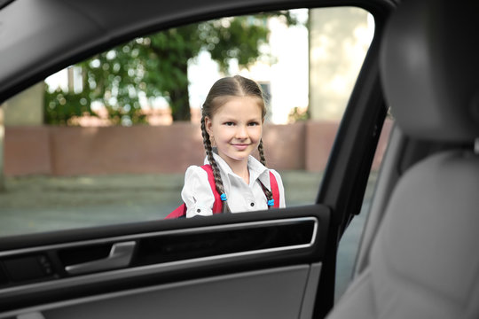 Taking Pupil After School. Girl Getting In Car