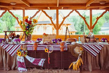 Buffet with alcohol and meat decorated in ethnic style
