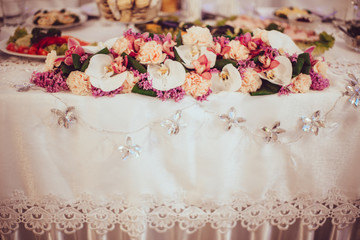 Crystal flowers hang from the wedding dinner table