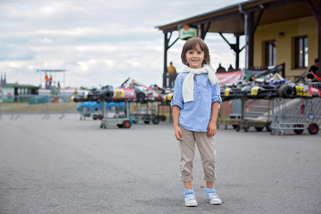 Two children, watching go cart race competition