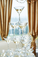 glasses with alcohol drinks in pyramid