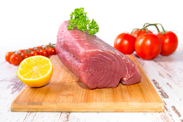 Raw tuna steak on wooden cutboard