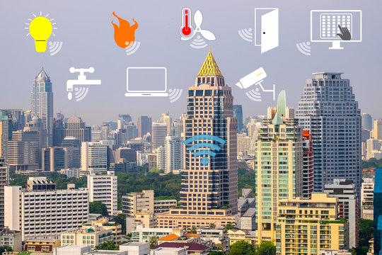 Smart Building and Internet of Things concept. Smart building management icons on Building in the city background.