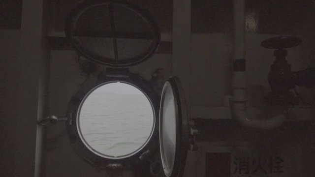 Video with view through a ship's porthole on the sea