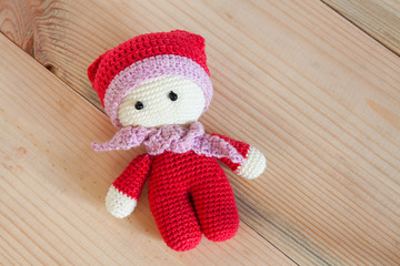 Crochet soft toy on a wooden background