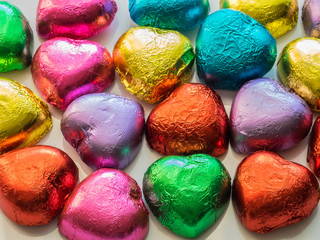 Valentine's heart-shaped chocolates wrapped in  wrapped in color