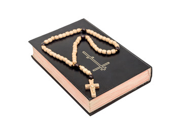 Bible with rosary beads isolated on white