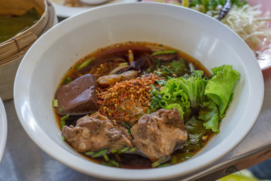 Thai rice noodles soup with pork and dried chili