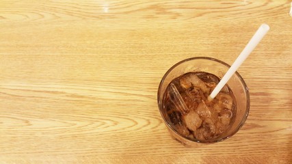 Glass of beverage on table. Glass of soft drink on table