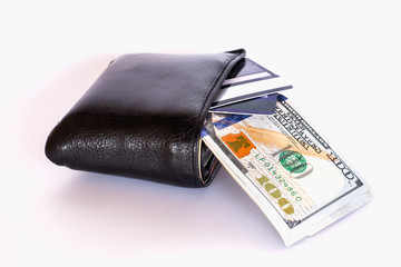 Credit cards and US dollar bank notes sticking out of the wallet on white background.