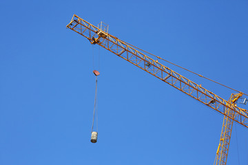 Naklejka premium construction crane hoisting cement bucket mixer pouring
