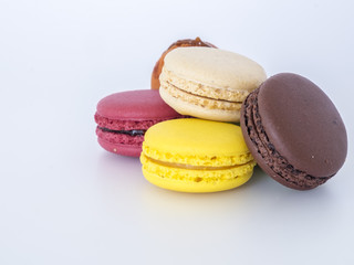 Sweet and colourful french macarons on white background.
