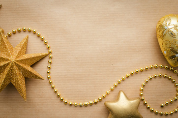 glass golden christmas decorations background on vintage craft paper space for copy text