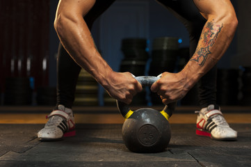 Fototapeta na wymiar Man exercising with kettlebell in crossfit gym