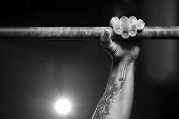 Male hand holding pull ups bar