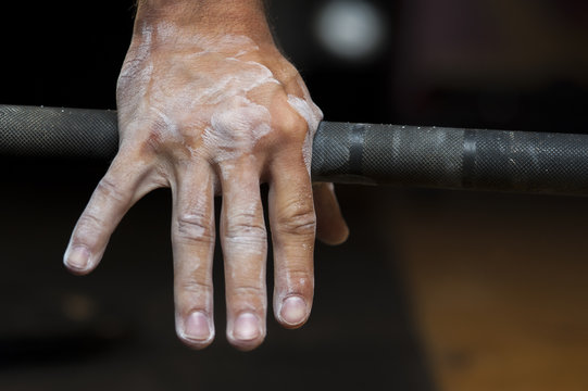 Closeup of male hand holding barbell