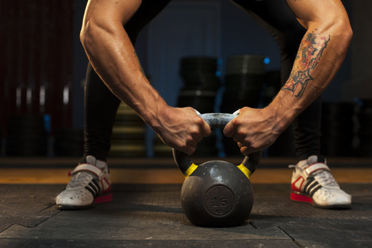 Man exercising with kettlebell in crossfit gym