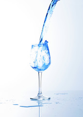 Blue drink splash into wine glass