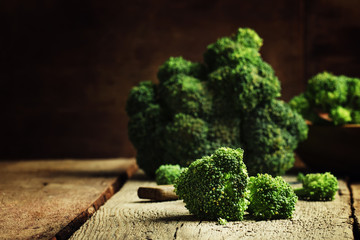 Pieces of broccoli cabbage on old wooden table, selective focus