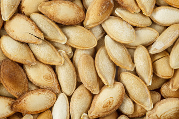 Whole roasted salted pumpkin seeds, macro shot