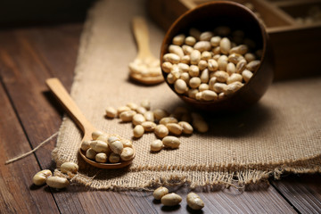 Fried beans in a bowl and wooden spoon
