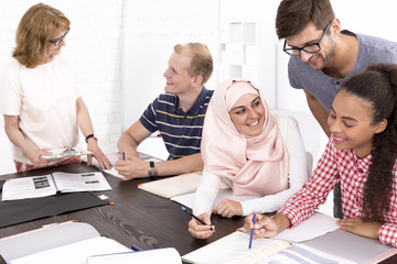 Man helping his freinds to make the language tasks