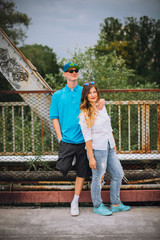 Obraz premium Portrait of a couple holding hands while walking outdoors. Couple enjoying outdoors in a urban surroundings.