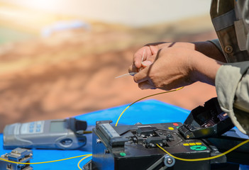 Technicians are cutting and fusion fiber optic cables.