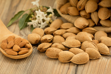 Almonds on brown wooden background