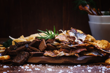 Dried fish and crackers. Vintage wooden background, selective fo