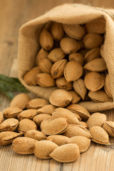 Almonds on brown wooden background