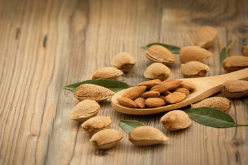 Almonds on brown wooden background