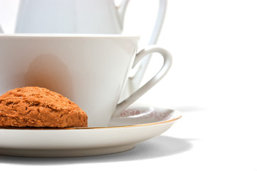 cup on a saucer and biscuits