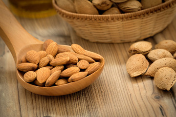 Almonds on brown wooden background