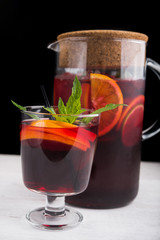 Hibiscus tea in glass with sliced orange fruit