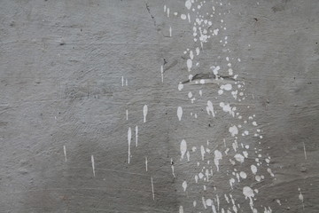 Concrete grey wall with splashes of white paing