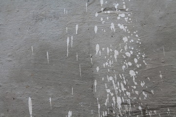 Concrete grey wall with splashes of white paing