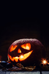 Halloween pumpkin, dark wooden background, selective focus