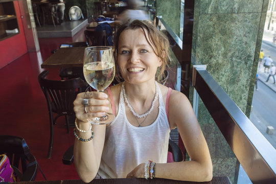 Woman with glass of wine doing cheers
