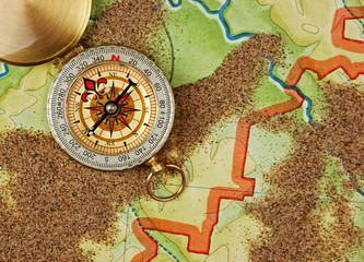 compass on the map with sand
