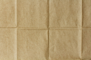 texture of crumpled brown packaging paper with folds