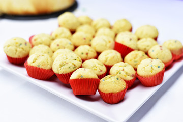 buffet with muffins or vanilla cupcakes