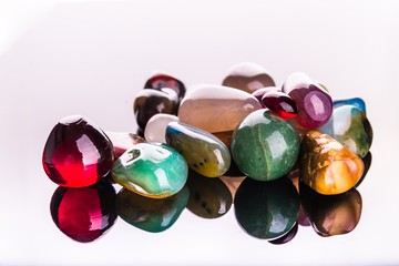 Collection of Colorful Semiprecious Gemstones on White Background.