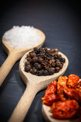 Chili with black pepper and salt on rustic stone background. Overhead view food photography.